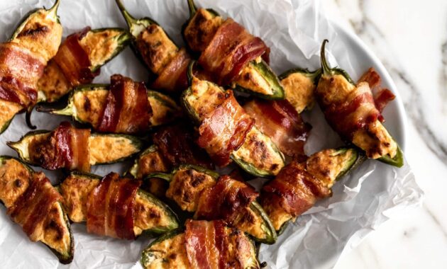 Bacon wrapped jalapeño poppers cooking with cocktail rings