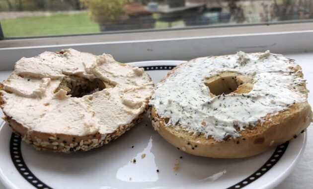Toasted everything bagel with dill cream cheese on one side, and