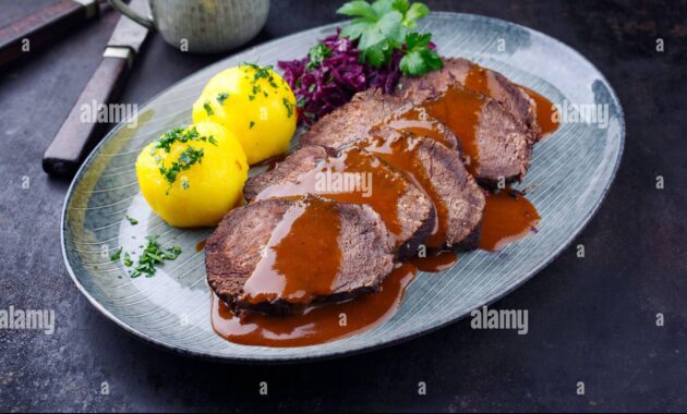 Traditional braised marinated German Sauerbraten from beef with blue