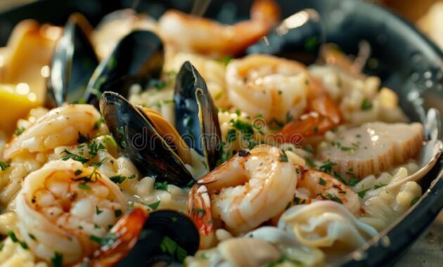 classic-risotto-ai-frutti-di-mare-creamy-seafood-shrimp-scallops-mussels-squid-finished-white-wine-parsley-339466099